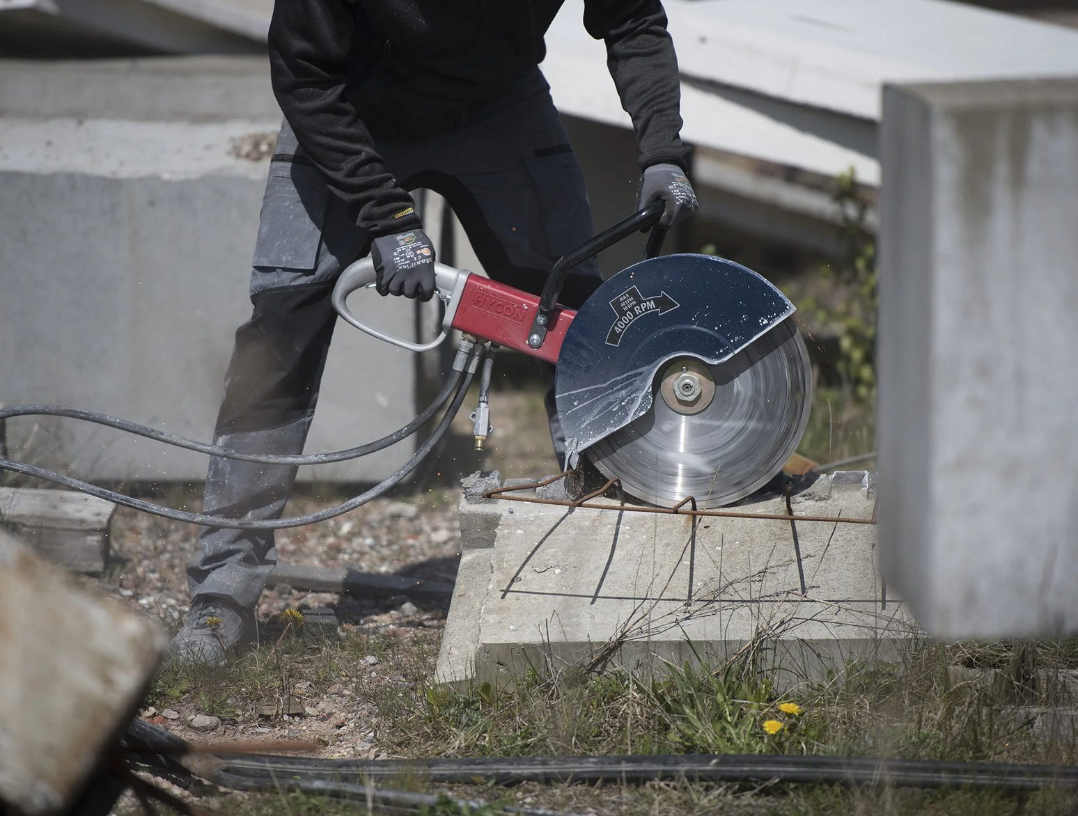 Hand saw cutting concrete wall